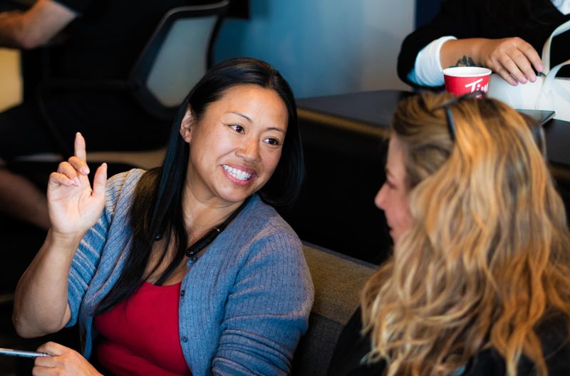An agent raising her hand to ask a question