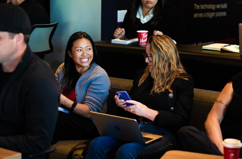 Two agents sharing a laugh on the couch