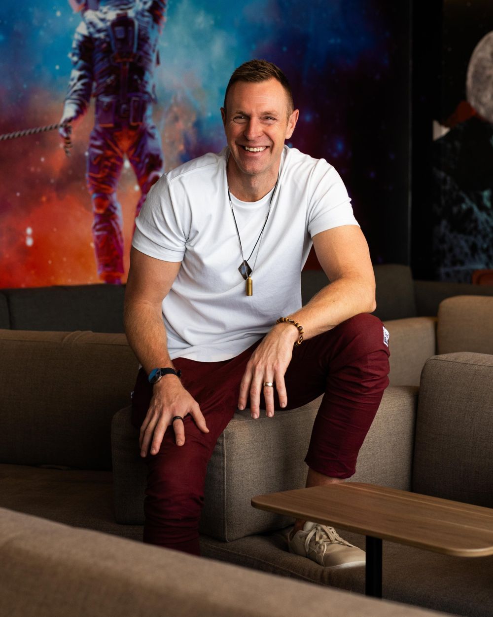 Darren Langille smiling, sitting on a lounge sofa
