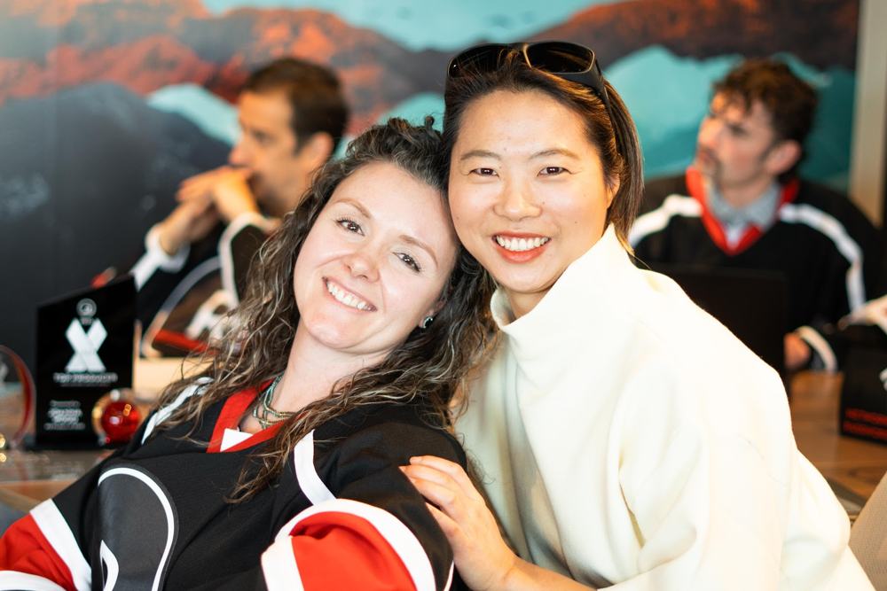 Two agents hugging and smiling at awards night