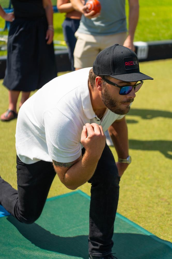 An agent celebrating a lawn bowling shot