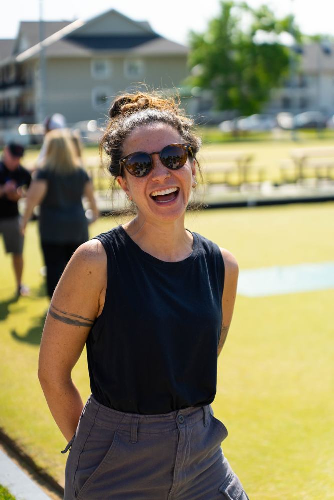 An agent laughing on the lawn bowling green