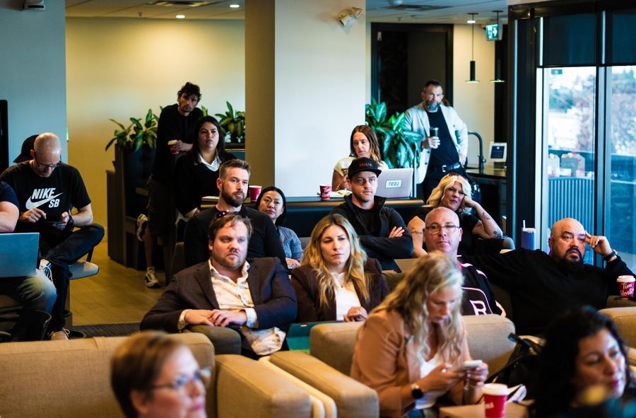 A room of agents laughing at a brokerage meeting